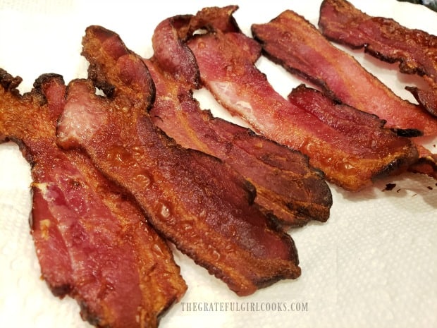 The finished air fryer bacon on paper towels to absorb any grease.