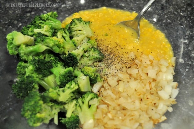 Creamed corn, onions, broccoli and spices are combined in bowl.