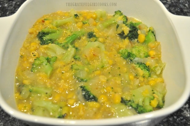 The casserole is poured into a greased oven-safe dish before baking.