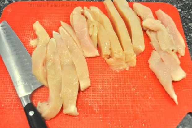 Boneless chicken breasts are cut into strips before adding spices.