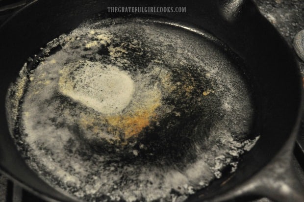 Butter is melted and heated in skillet before adding seasoned chicken strips.
