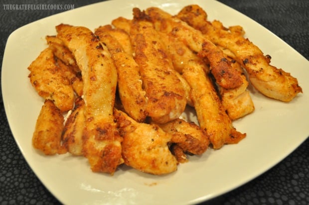 A plate full of cajun chicken strips, cooked and ready to eat!