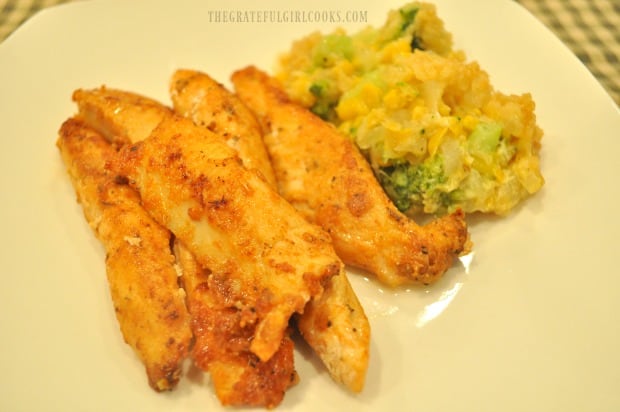 A few Cajun chicken strips, served with broccoli corn casserole on the side.