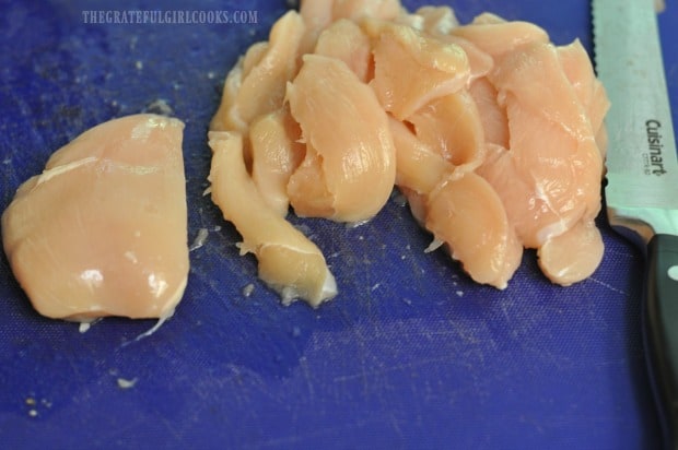 Boneless, skinless chicken breasts are cut into strips before cooking.