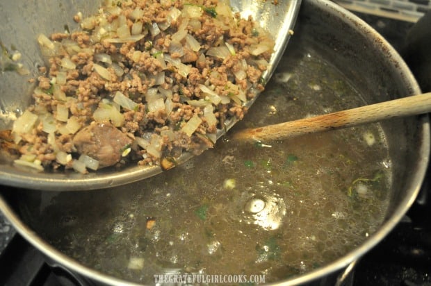 Cooked beef and onion mixture is added to beef broth.