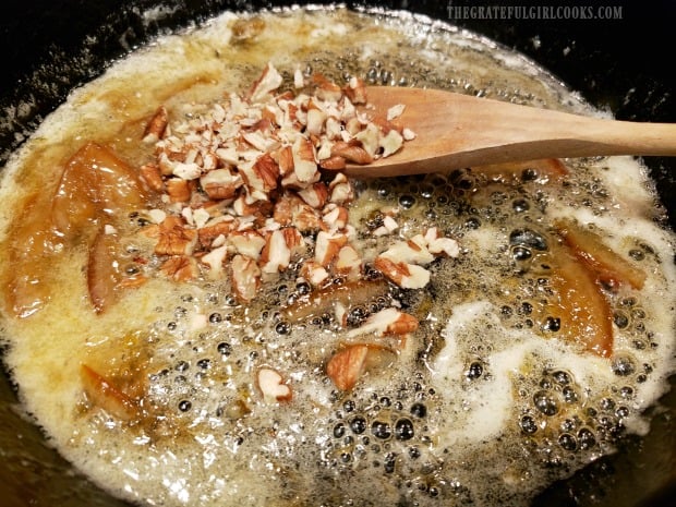 Chopped pecans are added to marmalade glaze in skillet.