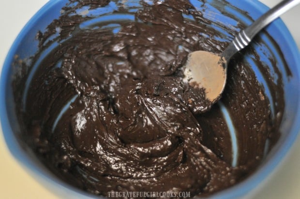 Once mixed together, the frosting becomes dark brown in color.