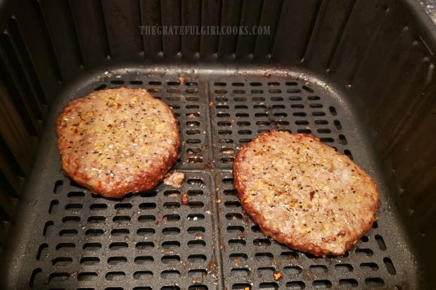 Burgers are cooked in air fryer, then flipped and cooked some more.