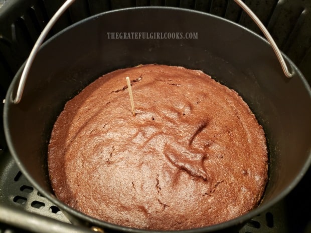 A toothpick is inserted into middle of brownies to ensure they are done.