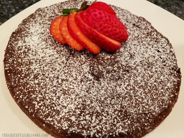 Garnished with sifted powdered sugar and a strawberry, they're ready to slice.