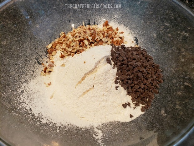Sifted dry ingredients, chocolate chips, and chopped pecans in mixing bowl.
