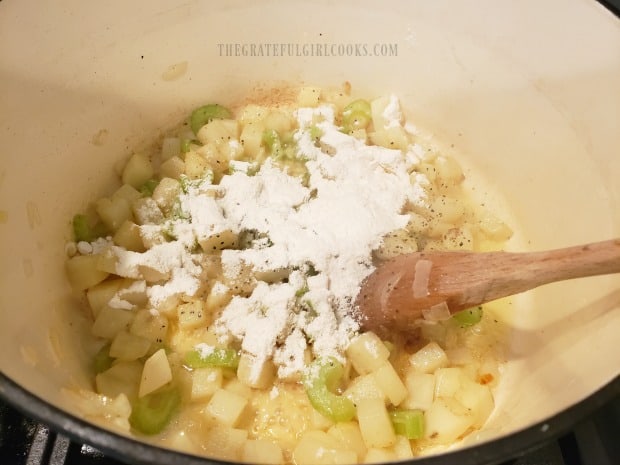 Flour is added into the potatoes to thicken soup as it cooks.