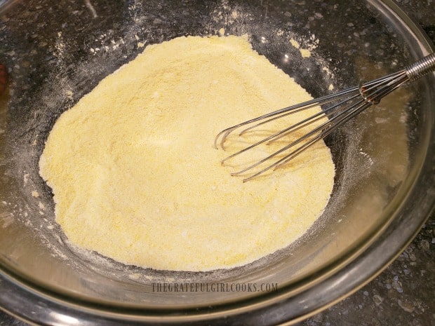 Flour, cornmeal and other dry ingredients are whisked together to mix.