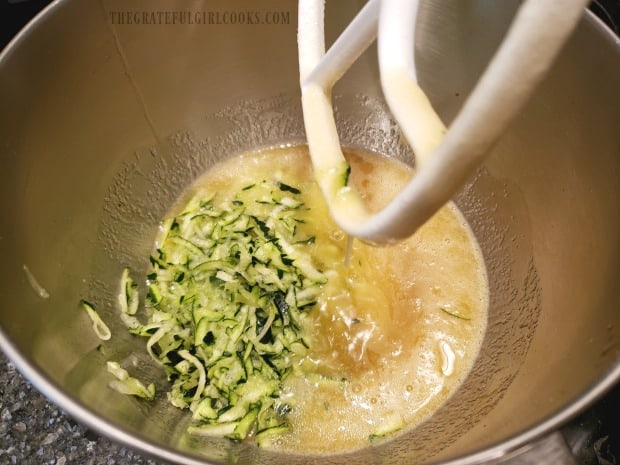 The grated zucchini is added to the wet bread ingredients and mixed together.