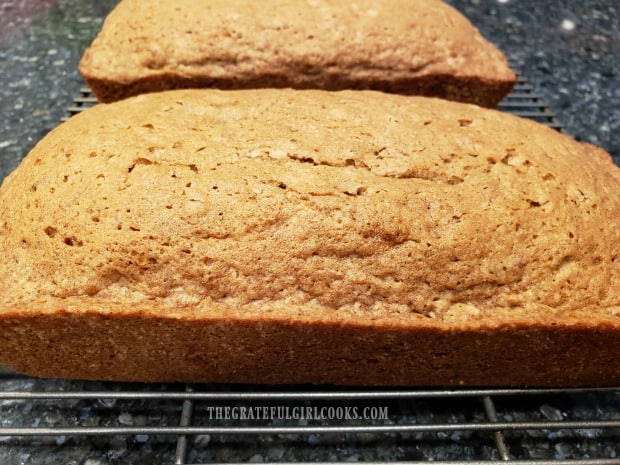 Cooling loaves of bread on wire racks, before slicing.