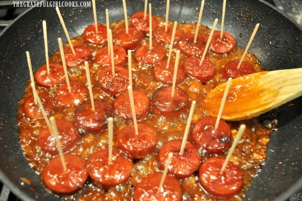 Each of the apricot pineapple kielbasa bites has a toothpick inserted into it.