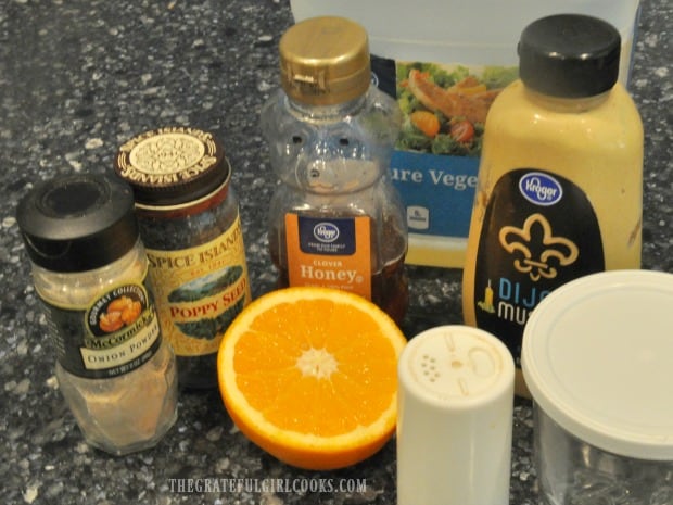 Ingredients are gathered to make a citrus dressing for the salad.