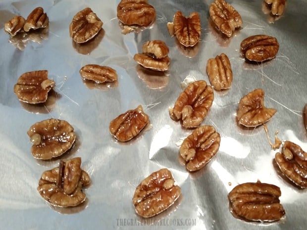 The candied pecans are dried until glaze firms up, then added to salad.