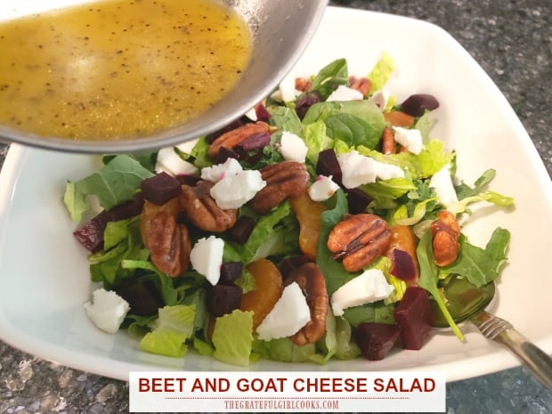 Colorful and delicious beet and goat cheese salad features mixed greens, candied pecans, mandarin oranges, beets, and goat cheese w/ citrus dressing!