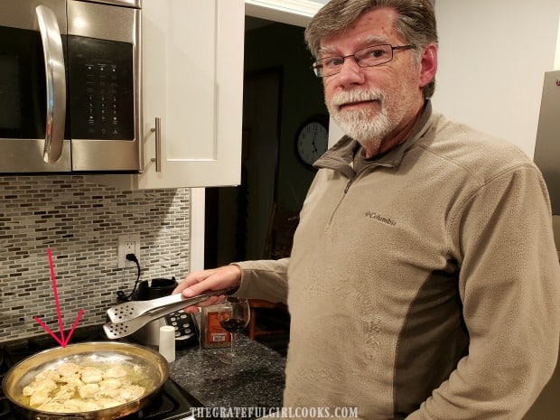 Pan-searing the chicken breast portions in butter.