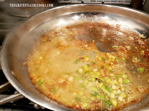 Lemon juice, zest, green onions and seasonings are cooked in skillet.