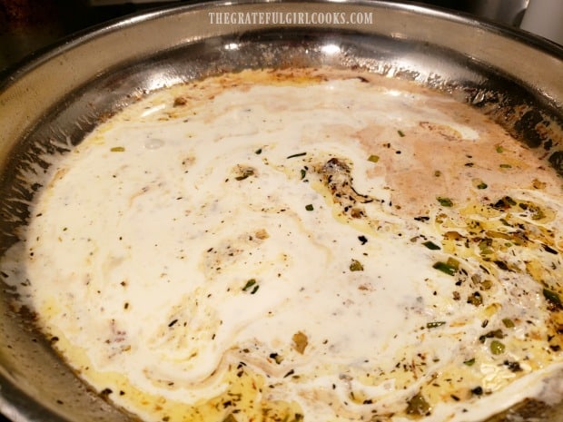 The creamy lemon sauce is stirred and cooked until slightly thickened.