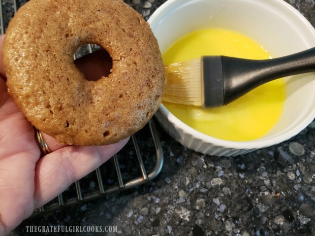 Each baked doughnut is brushed with melted butter on top.