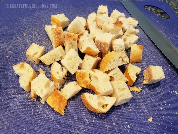 Day old french bread is cut into cubes for this recipe.