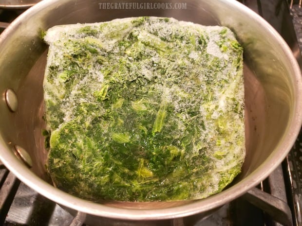 Frozen spinach is cooked according to package directions.
