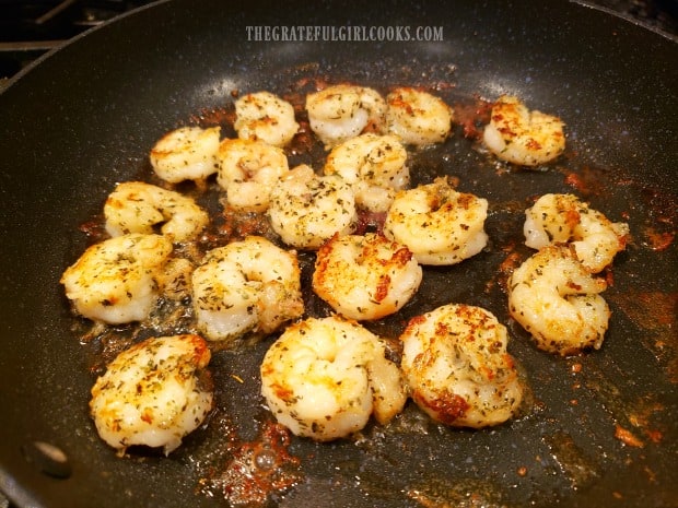 Shrimp are lightly seasoned, then pan-seared in butter in a skillet.