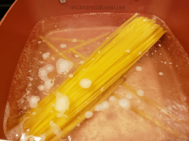 Fettucine pasta is cooked until al dente in boiling water.
