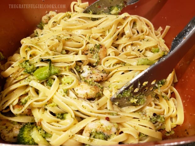 The herbed shrimp broccoli pasta is gently tossed before serving.