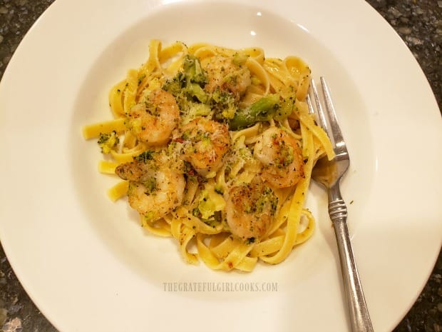 A serving dish of herbed shrimp broccoli pasta, ready to enjoy!