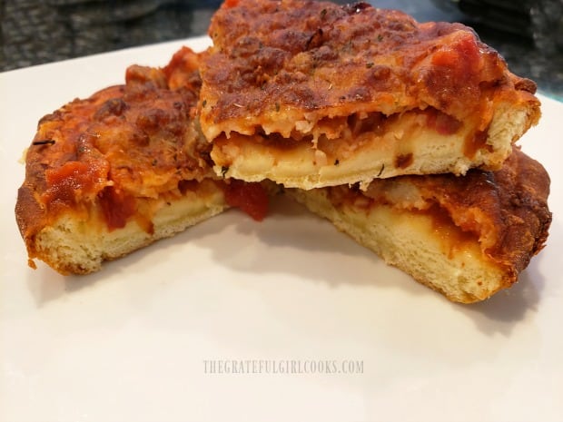 Slices of the air fryer cheesy pan pizza, on a plate, ready to eat.