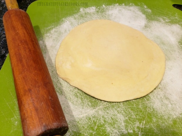 The biscuit dough is rolled out into a 6" circle for the pizza pan.