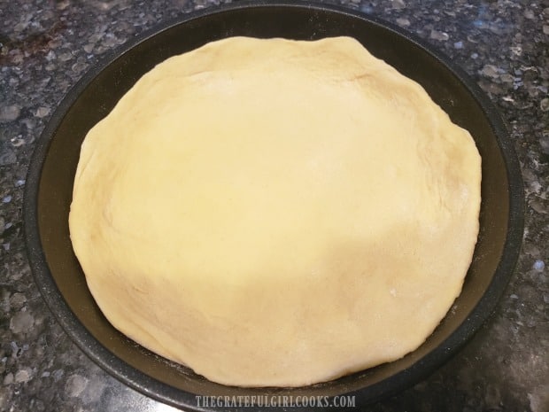 Place the dough into a 6" oven-proof pan, pulling dough up sides of pan to form rim.