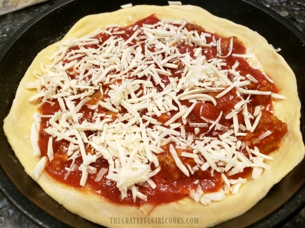 Spoon sauce over pizza, then top with grated Parmesan.