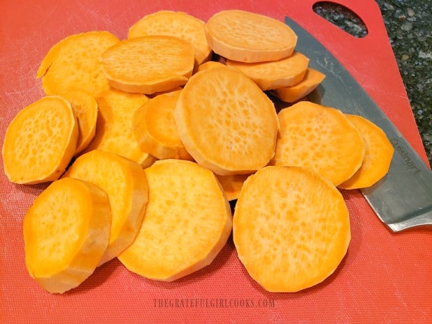 Sweet potatoes are peeled, then cut into 1/2" thick round slices.