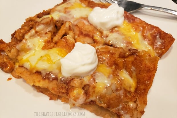 The easy cheesy enchiladas can be garnished with sour cream for serving.