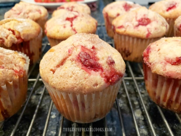 The strawberry muffins cooling on a wire rack.