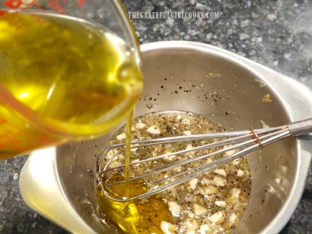 Olive oil is whisked into the lemon marinade until incorporated.