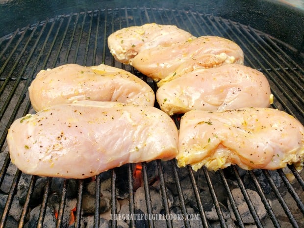 Grilled Lemon Chicken Breasts cooking over hot coals on BBQ.