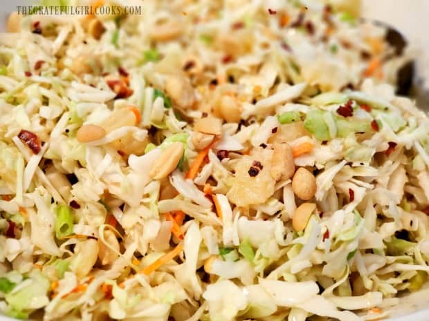 Peanuts and red pepper flakes garnish the chilled coleslaw.