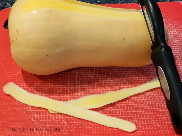 Use a vegetable peeler to peel the butternut squash.
