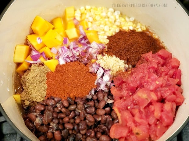 The ingredients for the black bean butternut squash chili in a large stockpot.