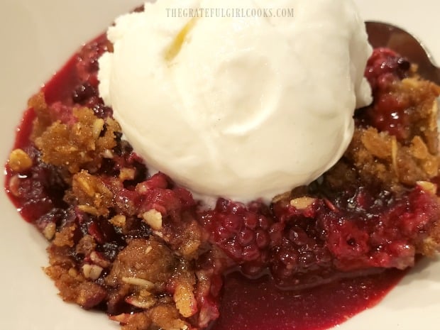 A scoop of vanilla ice cream tops off the blackberry crisp for serving.