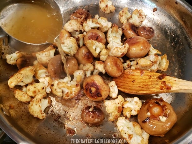 Vegetable (or chicken) stock is poured into the skillet with the veggies.