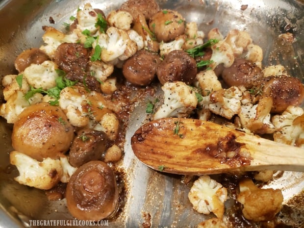 The cauliflower mushroom skillet is seasoned with salt/pepper and garnished with parsley.