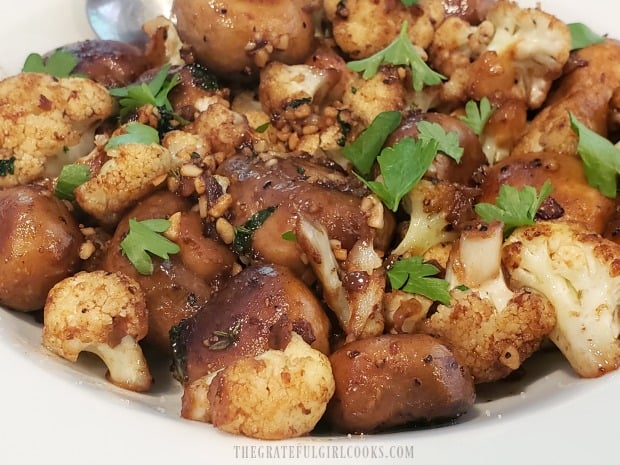 A close up look at the cauliflower mushroom skillet in a white serving bowl.