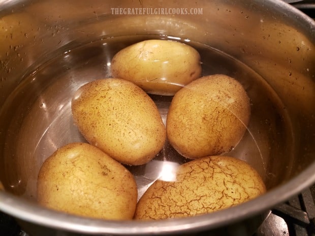 Par-boiling the potatoes for 8-9 minutes in water.